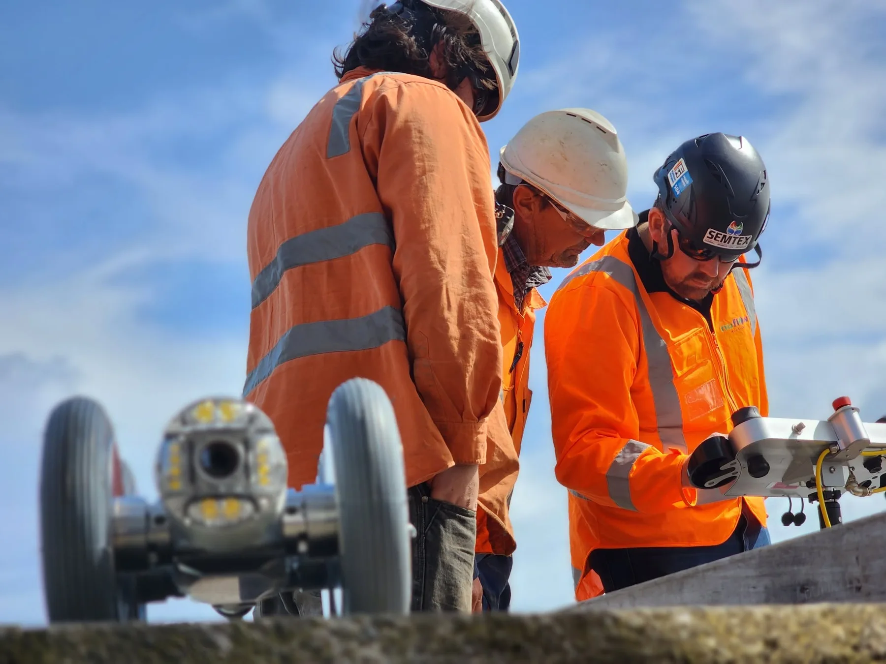 Technicians preparing a robotic CCTV pipe inspection camera