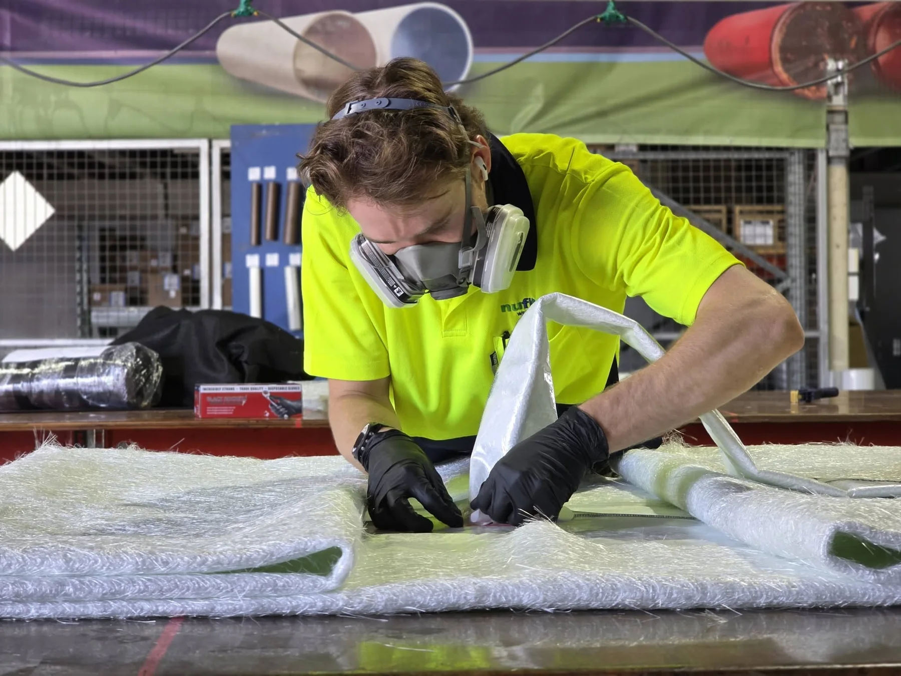 Nuflow technician wearing protective equipment while preparing pipe lining material